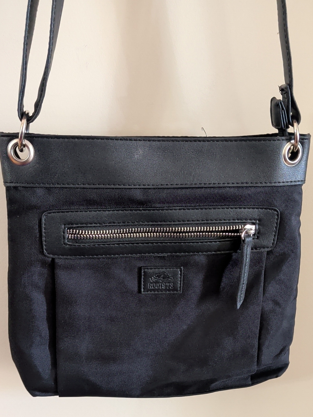 Roots Black Crossbody Bag with Front Zip and Grommet Strap
